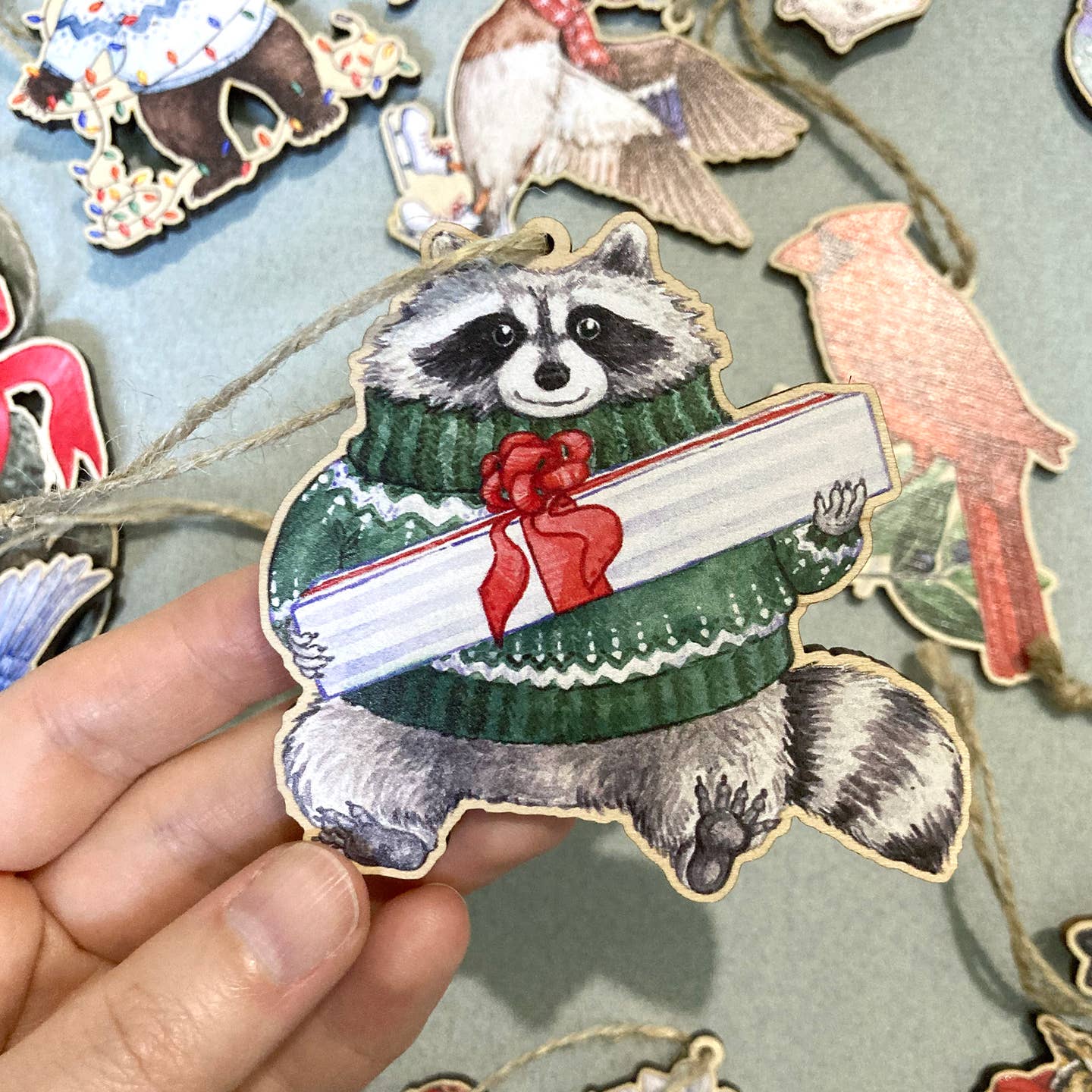 FESTIVE RACCOON WOODEN HOLIDAY ORNAMENT - Image 2